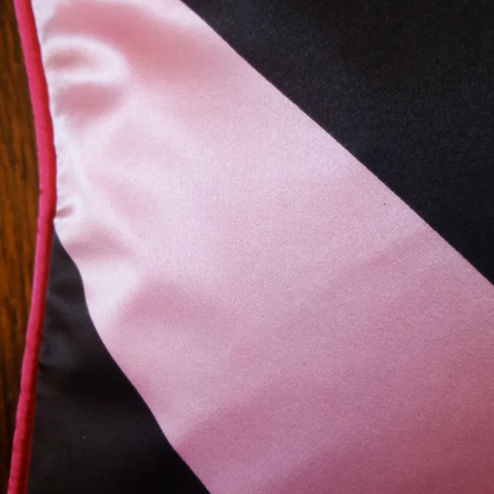 Plush Living Criss Cross Nook Pillow. NWT. Brown and pink bold graphic